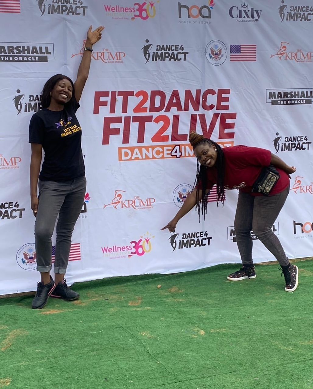 Volunteers at the Fit2Dance Dance4Impact event banner