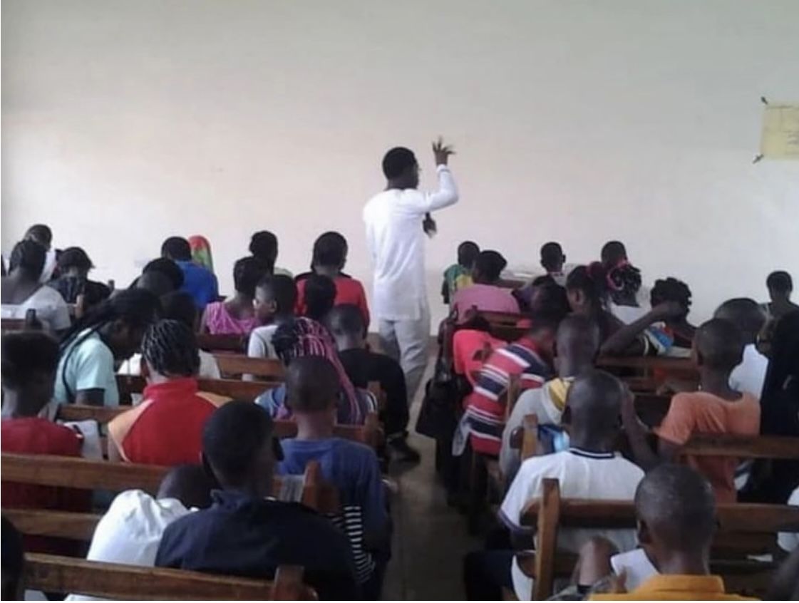A facilitator leading a group session in a community classroom