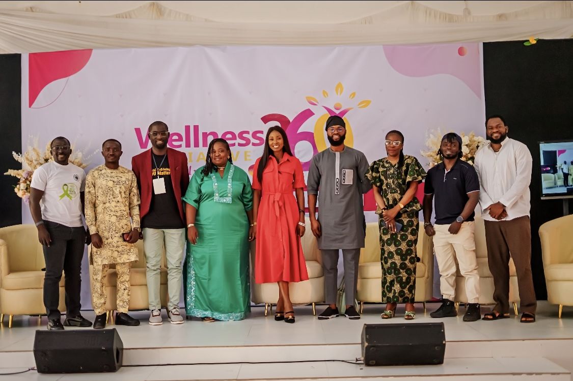 Speakers and partners on stage at a Wellness 360 advocacy event