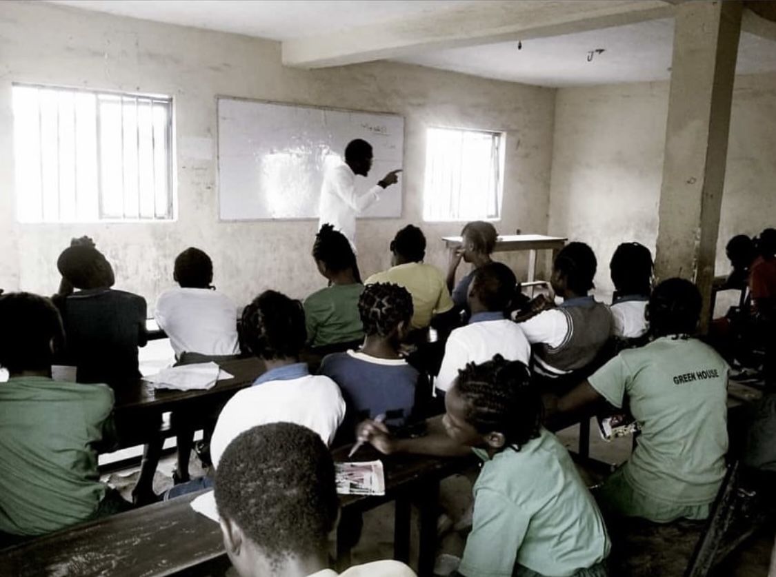 A trainer teaching a classroom session at the whiteboard